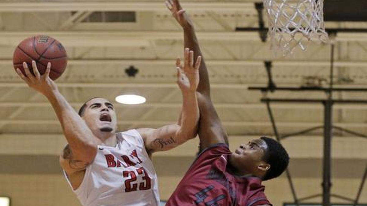 
Rugged inside play: Barry’s Yunio Barrueta, left, is fouled by Joe Lawson during the first half of Indianapolis’ 78-73 victory on Tuesday night.
