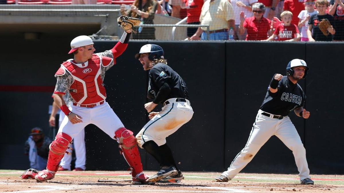 Coastal Carolina's Zach Remillard, center, and Michael Paez (1) celebrate after scoring on a hit by Seth Lancaster in the ninth inning o their 7-5 victory over North Carolina State in an NCAA college baseball regional game at Doak Field in Raleigh, N.C., Tuesday, June 7, 2016. N.C. State's Andrew Knizner (11) fields the ball.