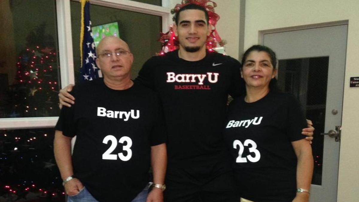 Barry standout Yunio Barrueta, middle, poses with his father, Fernando Barrueta, and mother, Martha Castillo.