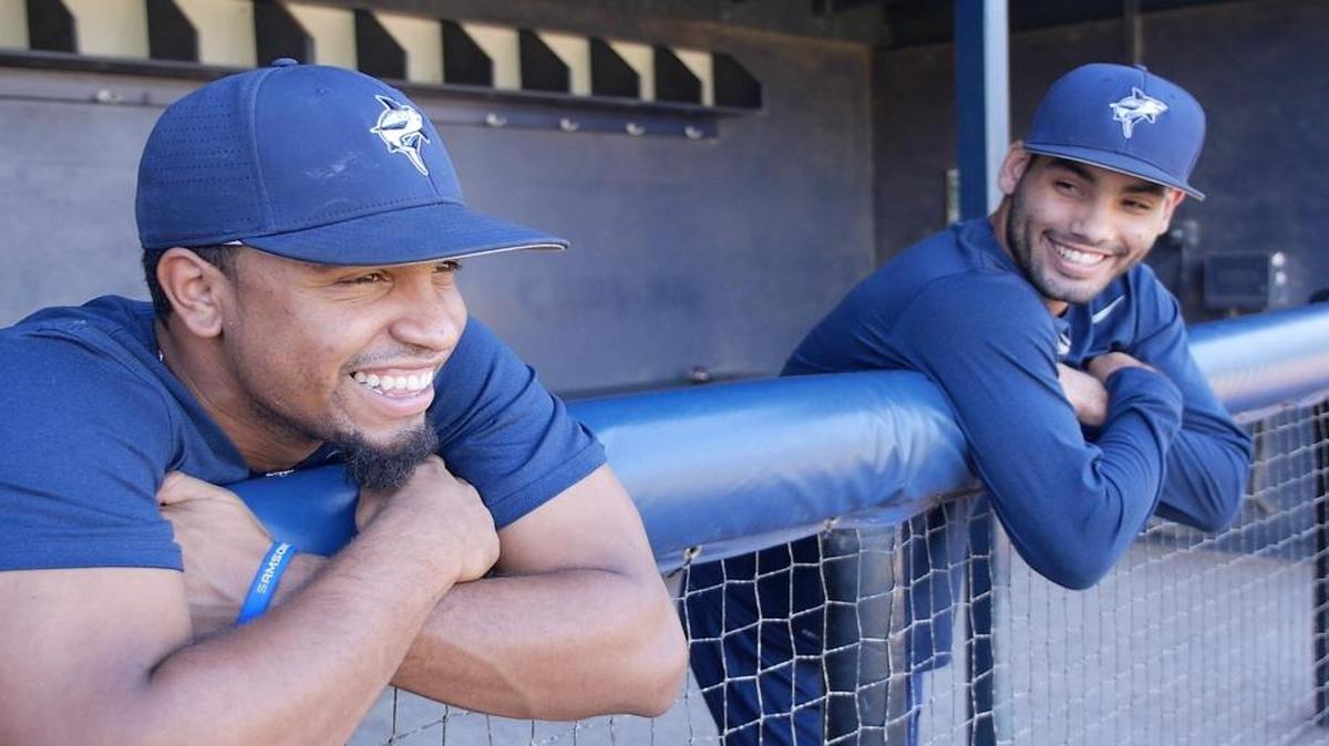 Gilberto Torres, right, and the Nova Southeastern baseball team raised $1,200 for teammate Ronny Orta to help him travel home to Venezuela.