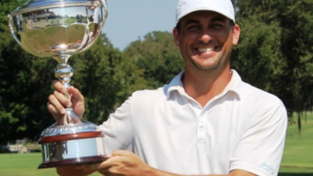 
TJ Shuart and his winner’s trophy for the Florida 2015 Mid-Amateur Championship.
