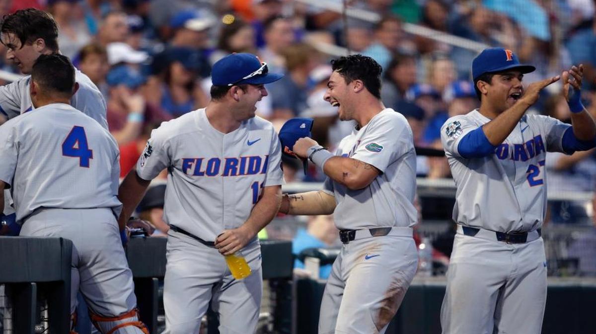 The Florida dugout reacts after watching replay of a score by Christian Hicks in the seventh inning of an NCAA College World Series baseball elimination game against TCU in Omaha, Neb., Saturday, June 24, 2017.