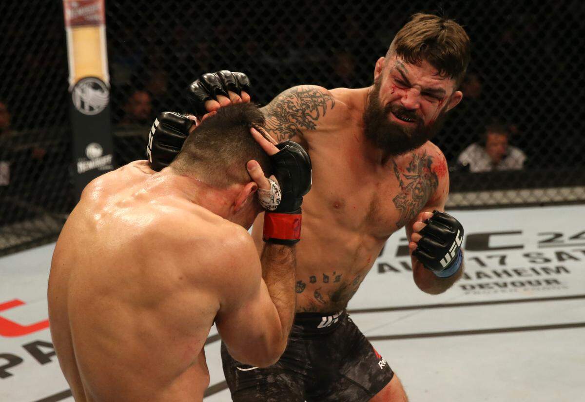 MONTEVIDEO, URUGUAY - AUGUST 10: (R-L) Mike Perry punches Vicente Luque in their welterweight fight during the UFC Fight Night event at Antel Arena on August 10, 2019 in Montevideo, Uruguay. (Photo by Alexandre Schneider /Zuffa LLC/Zuffa LLC)