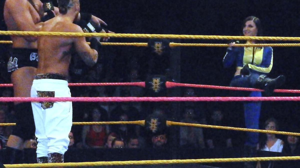 
Blue Pants, a.k.a indie wrestler Leva Bates, being introduced for the first time by Enzo Amore and Big Cass during a WWE NXT show in September 2014 at Full Sail Live at Full Sail University in Winter Park, near Orlando. She helped elevate Enzo and Big Cass’s favorite female wrestler, Carmella, in her debut, while surprisingly winning over the crowd.
