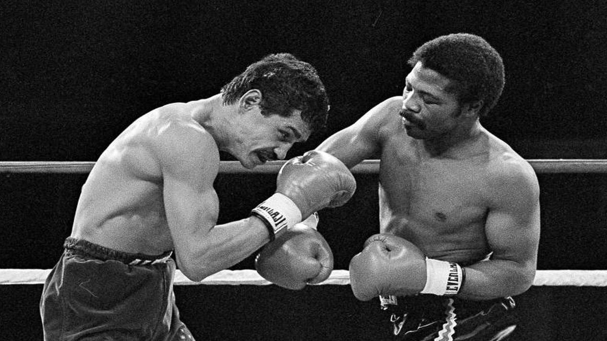 FILE - In this Nov. 12, 1982, file photo, Alexis Arguello covers up as defending champ Aaron Pryor throws a hard right during the second round of boxing action at the Orange Bowl in Miami. Pryor, the relentless junior welterweight died Sunday, Oct. 9, 2016, at the age of 60. Pryor's family issued a statement saying the former boxer died at his home in Cincinnati after a long battle with heart disease.