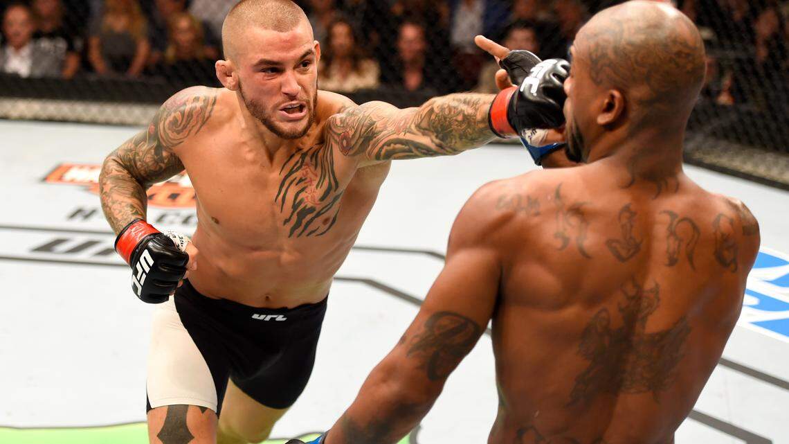 Dustin Poirier punches Bobby Green in their lightweight bout during the UFC 199 event on June 4, 2016, in Inglewood, California.