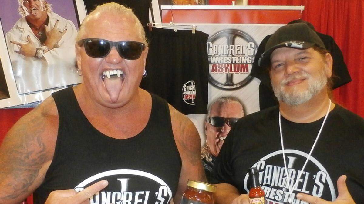 WWE alum Gangrel (left) and Jimmy Jannetty played integral roles in the Geoffrey the giraffe angle that went viral during the JJ Rumble of Fantasy Super Cosplay Wrestling on Friday, July 13, 2018 at Florida Supercon at the Broward County Convention Center in Fort Lauderdale. Jannetty, an ECW original who portrayed the FedEx delivery man, is one of the trainers at Gangrel’s Wrestling Asylum in South Florida. Will Geoffrey, formerly of Toys-R-Us, return for FSCW at the Raleigh Supercon from July 27-29 at the Raleigh Convention Center in Raleigh, N.C.?