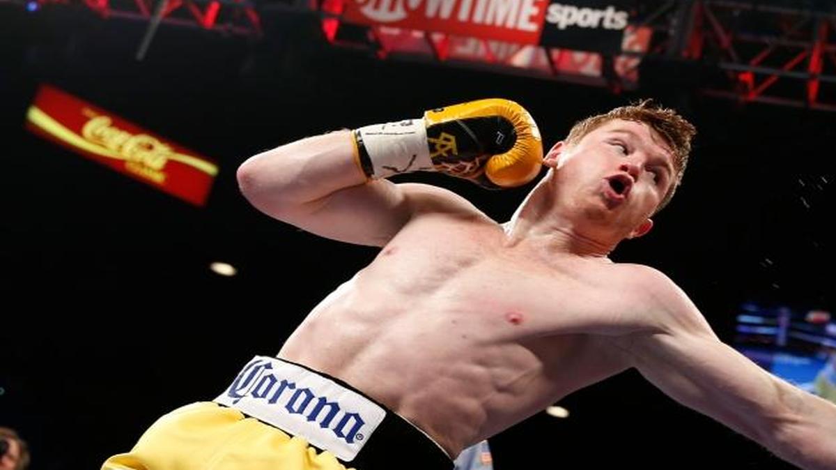 From the archives: This March 8, 2014, file photo shows Saul Canelo Alvarez, left, of Mexico, trading punches with compatriot Alfredo Angulo during a super welterweight boxing match in Las Vegas.