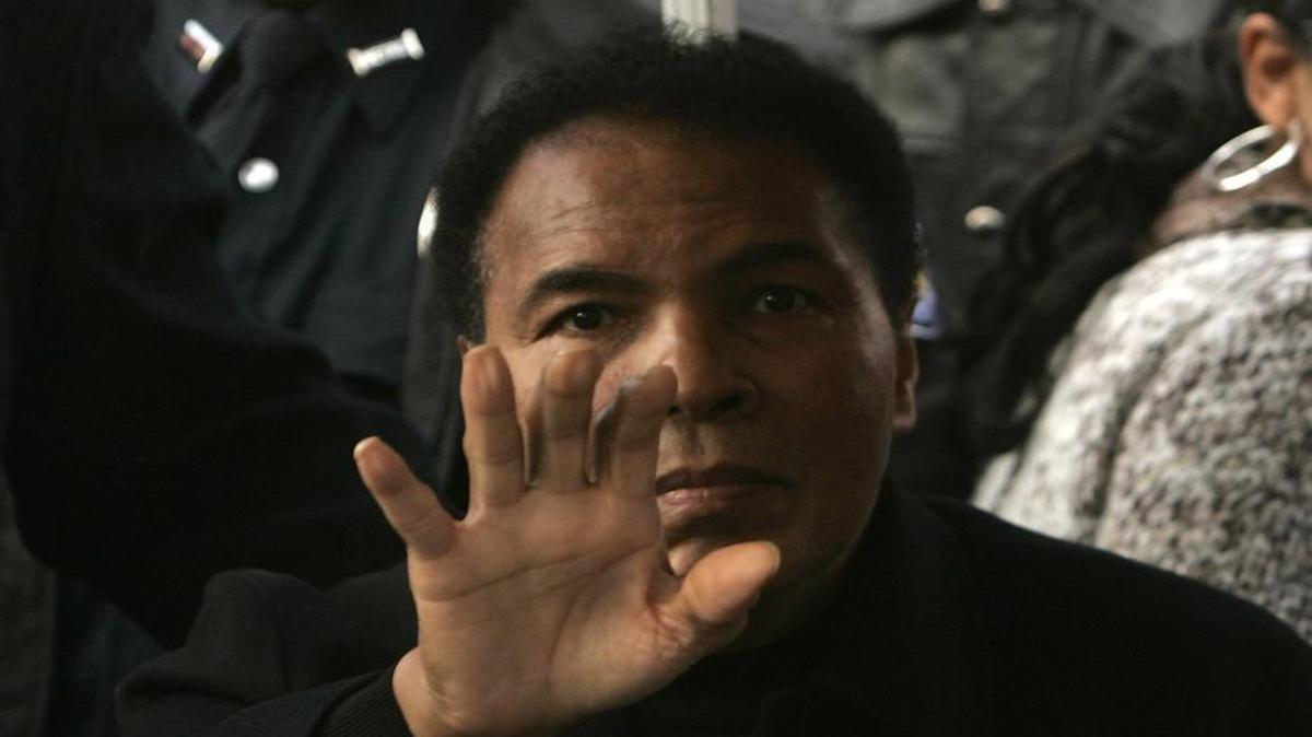 Muhammad Ali waves to people gathered for the dedication of the Muhammad Ali Center in Louisville, Kentucky, on November 20, 2005. Muhammad Ali died on Friday.