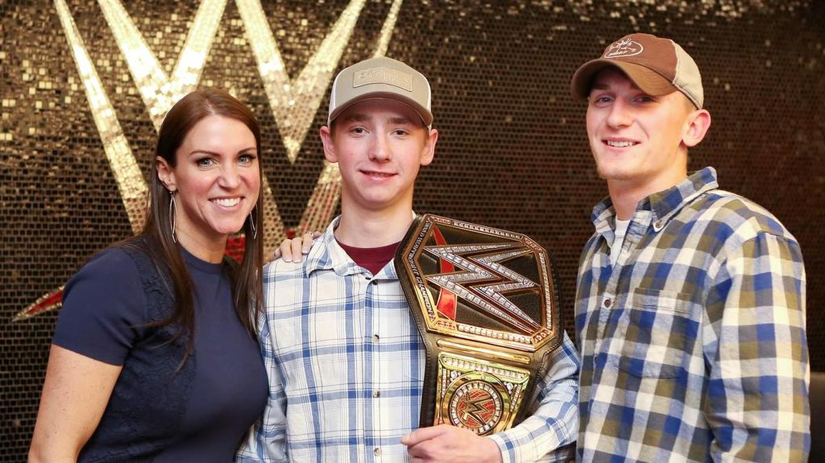 WWE hosted a special day on Thursday, April 28 (the day before World Wish Day) at its Stamford headquarters for 18-year-old Colby McMahon of Derby, Conn. Colby, who battles Cystic Fibrosis, dreamed to build and operate a state-of-the-art website (Tomorrow’s Sportsman) that celebrates and promotes outdoor sports and activities. Make-A-Wish Connecticut and WWE partnered to make Colby’s wish come true. Pictured are WWE Chief Brand Officer/TV Personality Stephanie McMahon, Colby (with belt) and Jake Bleau, Colby’s best friend and co-creator of Tomorrow’s Sportsman.