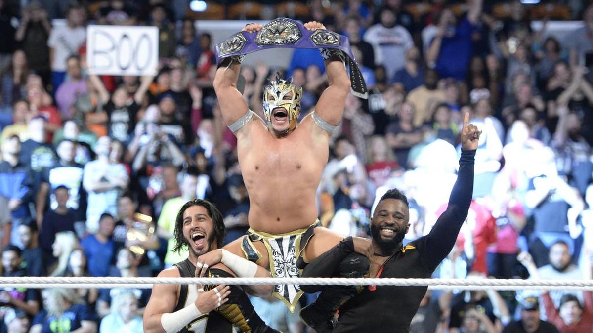 Kalisto is hoisted in the air by Mustafa Ali (left) and Cedric Alexander (right) after winning the WWE Cruiserweight title in the main event of Monday Night Raw on Oct. 9 in Indianapolis. Kalisto will defend the belt against former champ Enzo Amore at WWE Tables, Ladders & Chairs (Raw brand) PPV on Sunday, Oct. 22 live on WWE Network from the Target Center in Minneapolis, Minn.