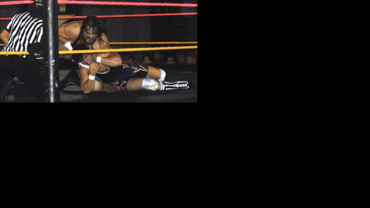 
Bull Dempsey headlocks Chad Gable during a WWE NXT show at the Havert L. Fenn Center in Fort Pierce. Dempsey and his NXT coaches and teammates will be participating with Special Olympians for a unique experience. They will join forces to pull a 50-ton jet on Saturday, Nov. 1 at Orlando International Airport.
