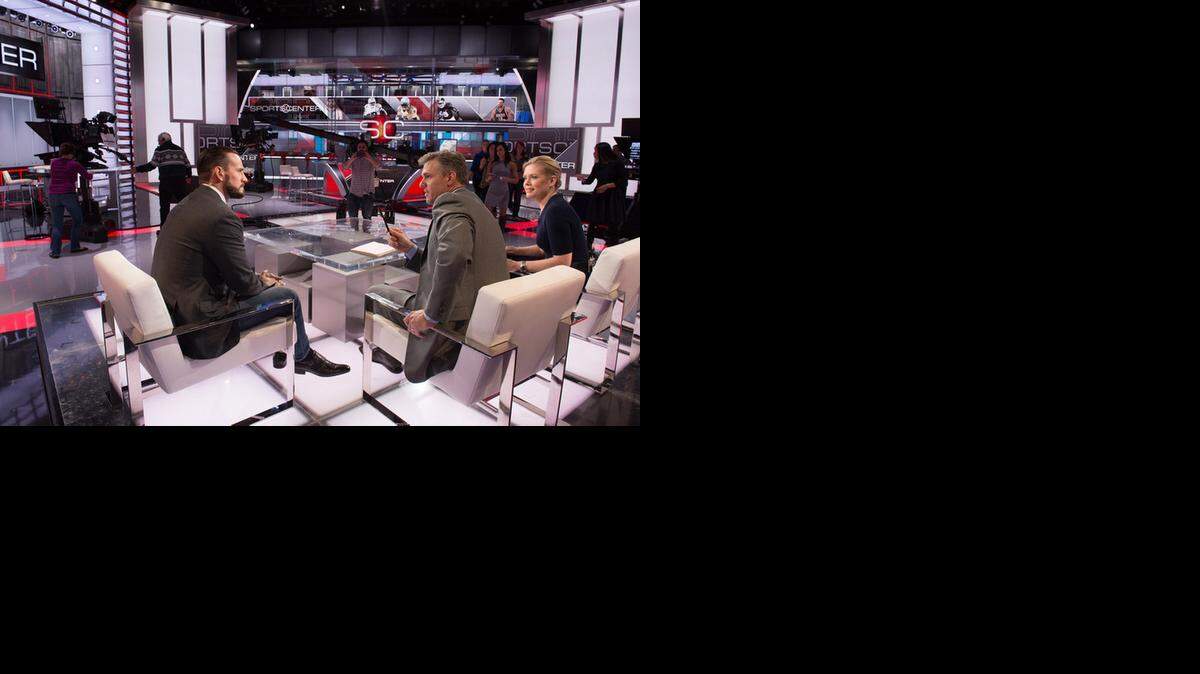 
Former WWE superstar CM Punk (Phil Brooks) was in studio on ESPN to discuss his foray into MMA with UFC. SportsCenter hosts Jay Crawford (middle) and Chris McKendry (right) interviewed him.
