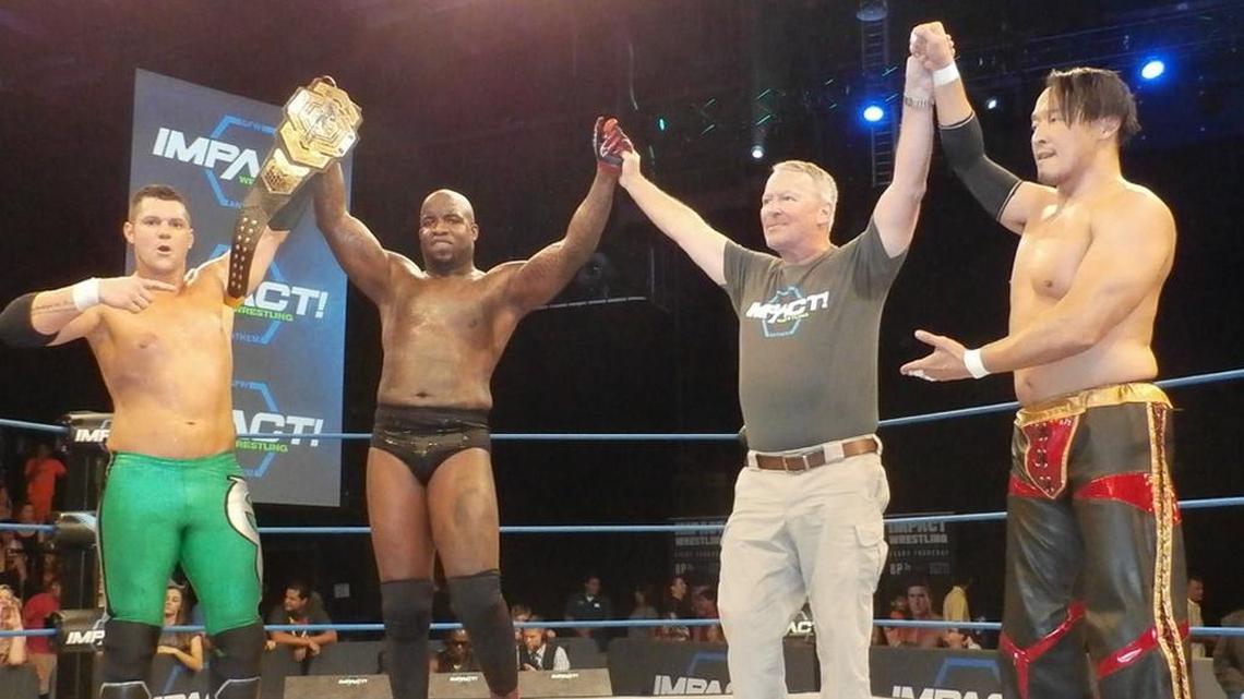 After serving as guest ring announcer for their six-man tag match, Orlando Mayor Buddy Dyer poses for a photo with Eddie Edwards (left), Impact Grand Champ Moose and Marufuji (right) during Impact Wrestling TV tapings for Pop TV in the Impact Zone on Wednesday, July 5 at Universal Studios Florida in Orlando. The Mayor proclaimed Wednesday, July 5, 2017 as “IMPACT WRESTLING DAY IN ORLANDO.”