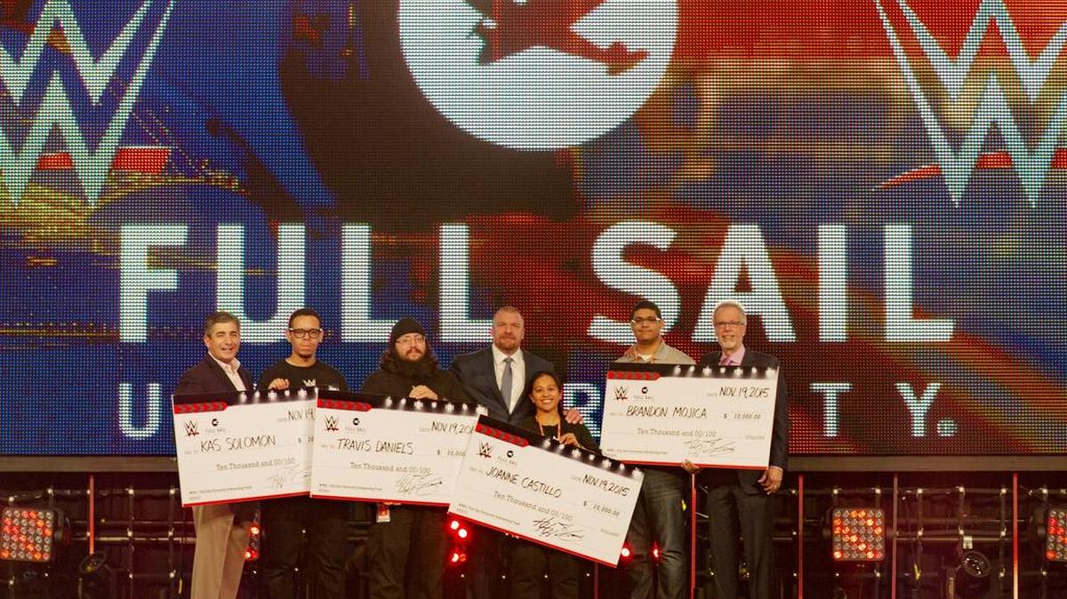 WWE recently awarded $10,000 scholarships to Full Sail University students Kas Soloman, Travis Daniels, Joanne Castillo, and Brandon Mojica. Pictured with these standouts are WWE Executive Vice President of Special Events John Saboor (left), WWE Executive Vice President (Talent/Live Events/Creative) Paul Triple H Levesque and Full Sail University President Garry Jones (right).
