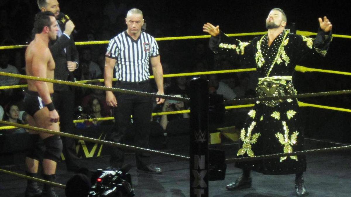 NXT Champ Glorious Bobby Roode wrestles Drew McIntyre for the title at NXT TakeOver: Brooklyn III on Saturday, Aug. 19 during WWE SummerSlam Weekend at Barclays Center. Also pictured are NXT Superstar Roderick Strong and Ring Announcer Mike Rome. Your referee Drake Wuertz.