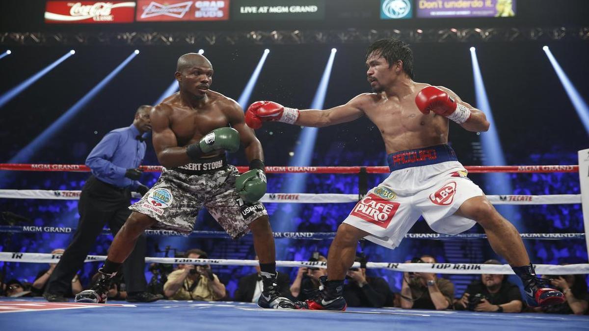 Timothy Bradley, left, and Manny Pacquiao, of the Philippines, face off in their WBO welterweight title boxing fight Saturday, April 12, 2014, in Las Vegas.