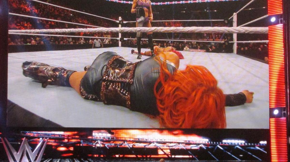 With a proud dad, Ric Flair, watching atop the rampway, WWE Divas Champ Charlotte stands over Becky Lynch and Sasha Banks. They are vying for spots at WrestleMania 32 on Sunday, April 3 at AT&T Stadium in Dallas.