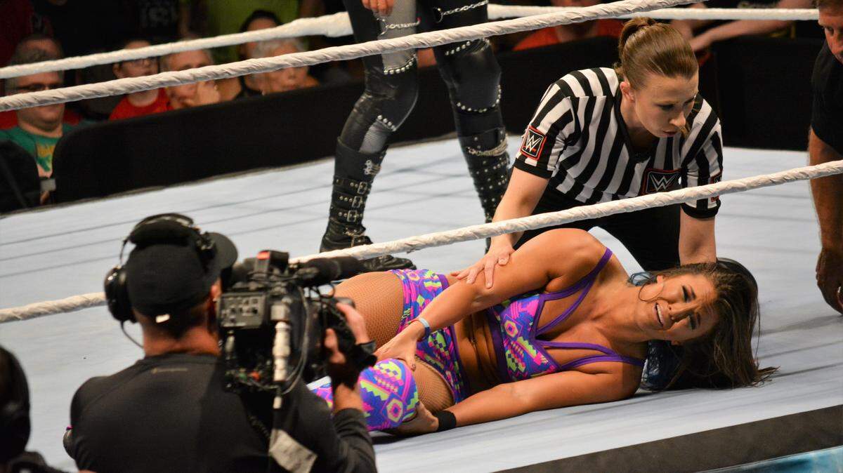 Referee Aubrey Edwards and medical personnel check Tegan Nox who injured her left knee during the second annual WWE Mae Young Classic on Thursday, Aug. 9 at Full Sail Live at Full Sail University in Winter Park, near Orlando. Nox, who missed last year’s inaugural all-women’s tournament with an injury to her other leg (ACL), was removed from this year’s event and taken to a nearby hospital.