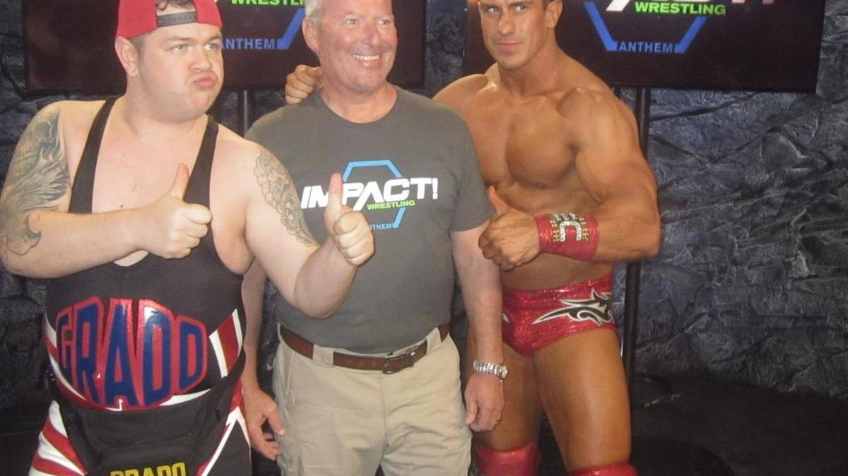 Grado and EC3 with Orlando Mayor Buddy Dyer during Impact Wrestling Day in the Impact Zone at Universal Studios Florida in Orlando. GFW Impact Wrestling TV tapings for Pop TV returns to the Impact Zone in August.
