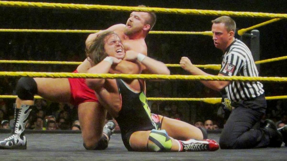 In NXT, Dash Wilder of The Revival headlocks Chad Gable of American Alpha, now members of SmackDown Live. American Alpha (Jason Jordan and Chad Gable) will be in Miami when WWE returns to South Florida for the holidays with a super SmackDown house show (no TV) on Friday, Dec. 30 at the AmericanAirlines Arena. Your referee Shawn Bennett.