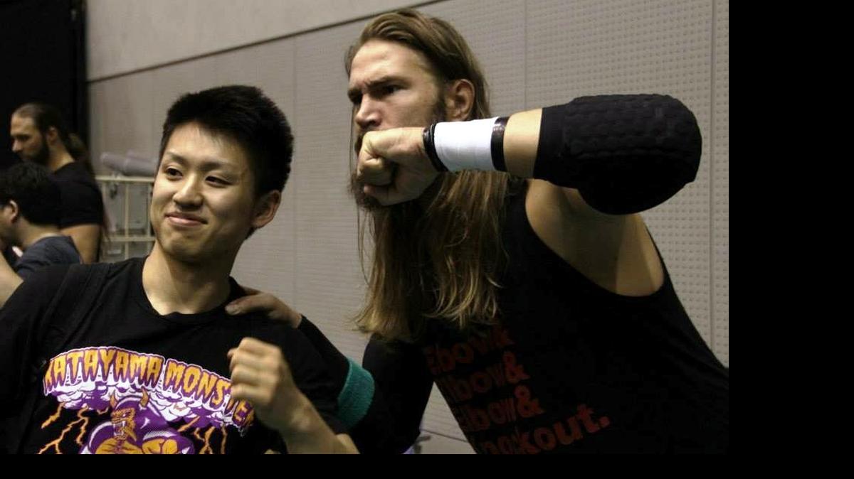
Standout indie wrestler Chris Hero (right) with a fan during the annual Mitsuharu Misawa Memorial show at the Hiroshima Green Small Arena in Hiroshima, Japan.
