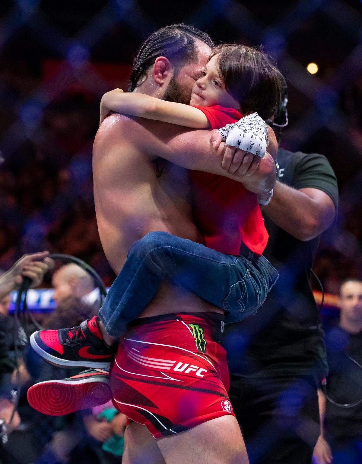 Jorge Masvidal hugs his son after losing his welterweight title match against Gilbert Burns during the UFC 287 event at the Kaseya Center on Saturday, April 8, 2023, in downtown Miami, Fla.