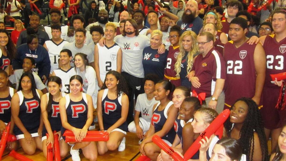 WWE talent, basketball players, coaches, cheerleaders, team managers and some of the crowd pose for a group photo after a Special Olympics Unified basketball game between Poinciana and St. Cloud high schools in Kissimmee. The event on Thursday, March 30 was hosted by WWE and Special Olympics Florida as part of WWE giving back to the area WrestleMania community during WrestleMania Week Orlando/Orange County.