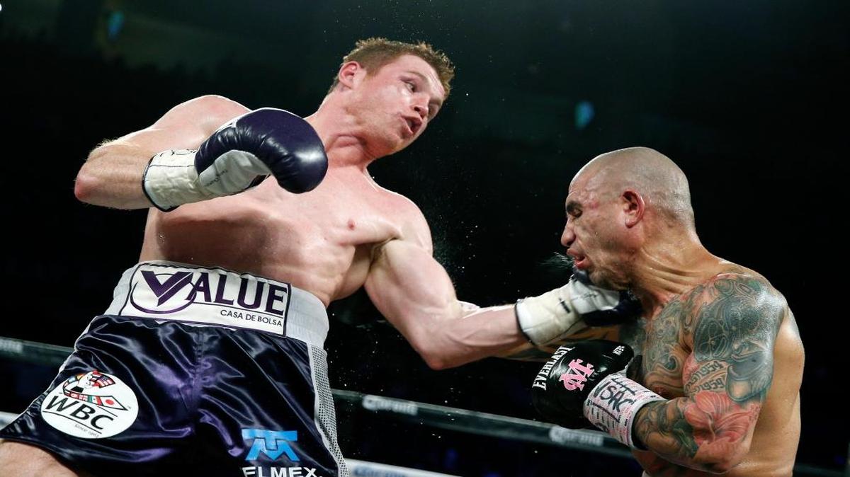 Miguel Cotto, right, of Puerto Rico, get hits by Canelo Alvarez, of Mexico, during a WBC middleweight title bout Saturday, Nov. 21, 2015, in Las Vegas.