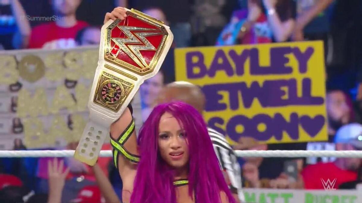 Sasha Banks won the Raw women’s title on Sunday, Aug. 20 at WWE SummerSlam from Barclays Center in Brooklyn. She earned a shot at the title, held by Alexa Bliss, after No.1 contender Bayley was injured legit. Notice the sign WWE captured behind Banks as she celebrates. Getting ready for an epic battle.