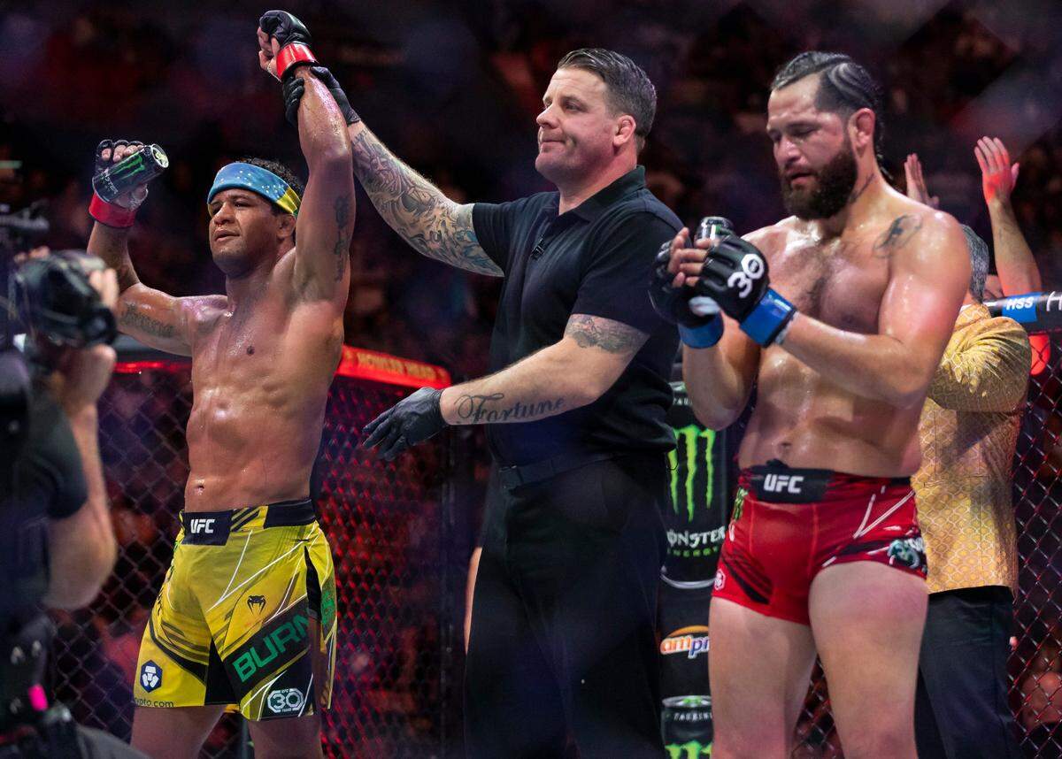 Gilbert Burns, left, defeats Jorge Masvidal in their welterweight title match during the UFC 287 event at the Kaseya Center on Saturday, April 8, 2023, in downtown Miami, Fla.