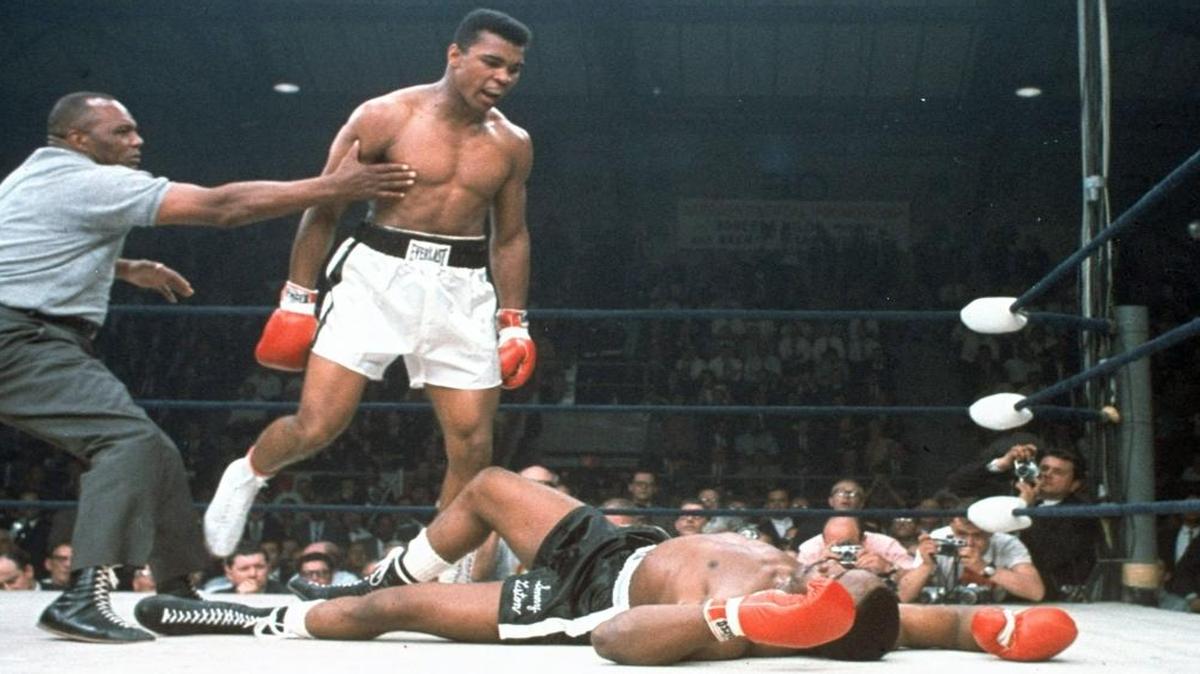 In this May 25, 1965, file photo, heavyweight champion Muhammad Ali is held back by referee Joe Walcott, left, after Ali knocked out challenger Sonny Liston in the first round of their title fight in Lewiston, Maine. Ali, the magnificent heavyweight champion whose fast fists and irrepressible personality transcended sports and captivated the world, has died according to a statement released by his family Friday, June 3, 2016. He was 74.