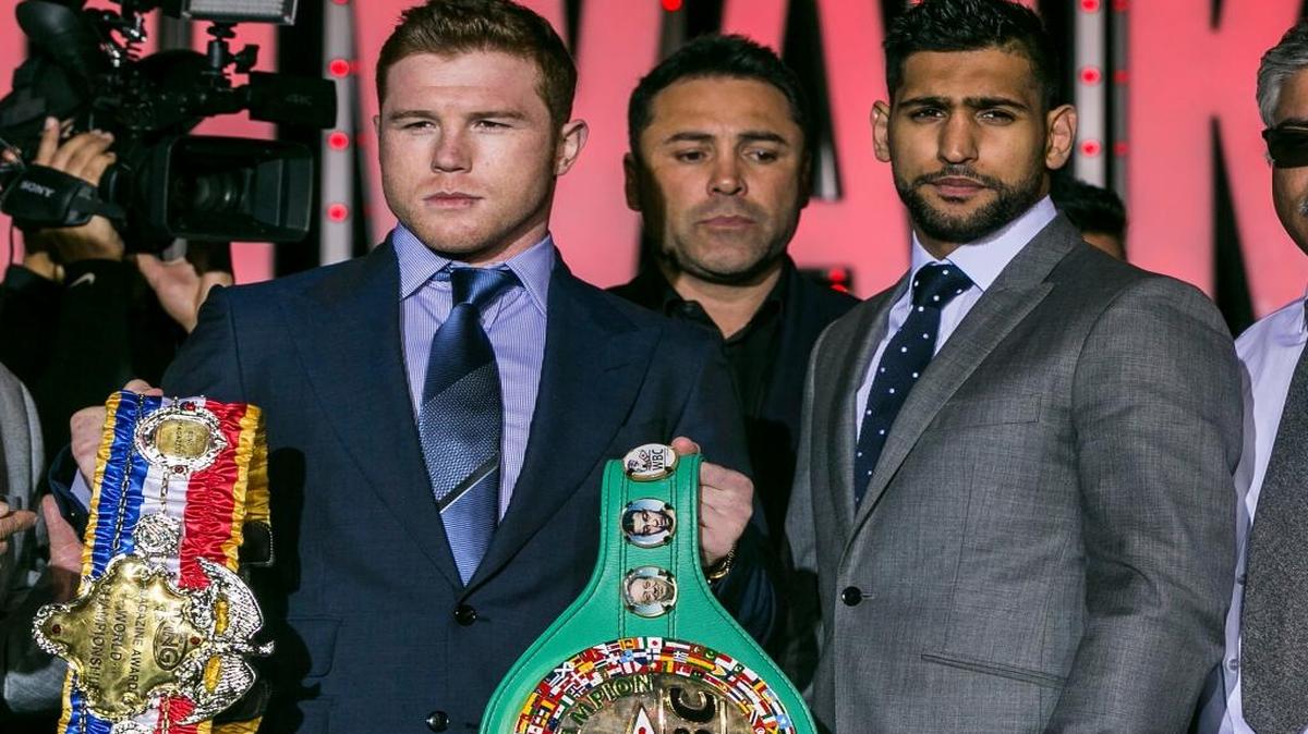 Canelo Alvarez, left, and Amir Khan, right, pose for a photo with promoter Oscar De La Hoya, center, in Los Angeles on Wednesday, March 2, 2016. The boxers are scheduled to fight on May 7 in Las Vegas for Alvarez's WBC middleweight title.