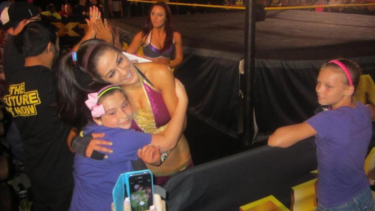 
New NXT women’s champ and fan favorite Bayley hugs a fan after her tag match during an NXT show at the Havert L. Fenn Center in Fort Pierce. NXT returns to the Havert L. Fenn Center on Saturday, Aug. 29.
