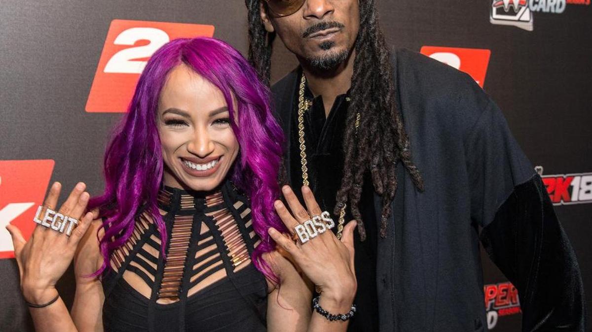 Sasha Banks with her cousin rapper, actor, businessman, guest DJ Snoop Dogg at the “WWE 2K18” and “WWE Supercard” Kickoff Event on Friday, Aug. 18 during SummerSlam Weekend at SIR Stage 37 in New York City. Banks is the former WWE Raw women’s champion, and Snoop is a WWWE Hall of Famer.