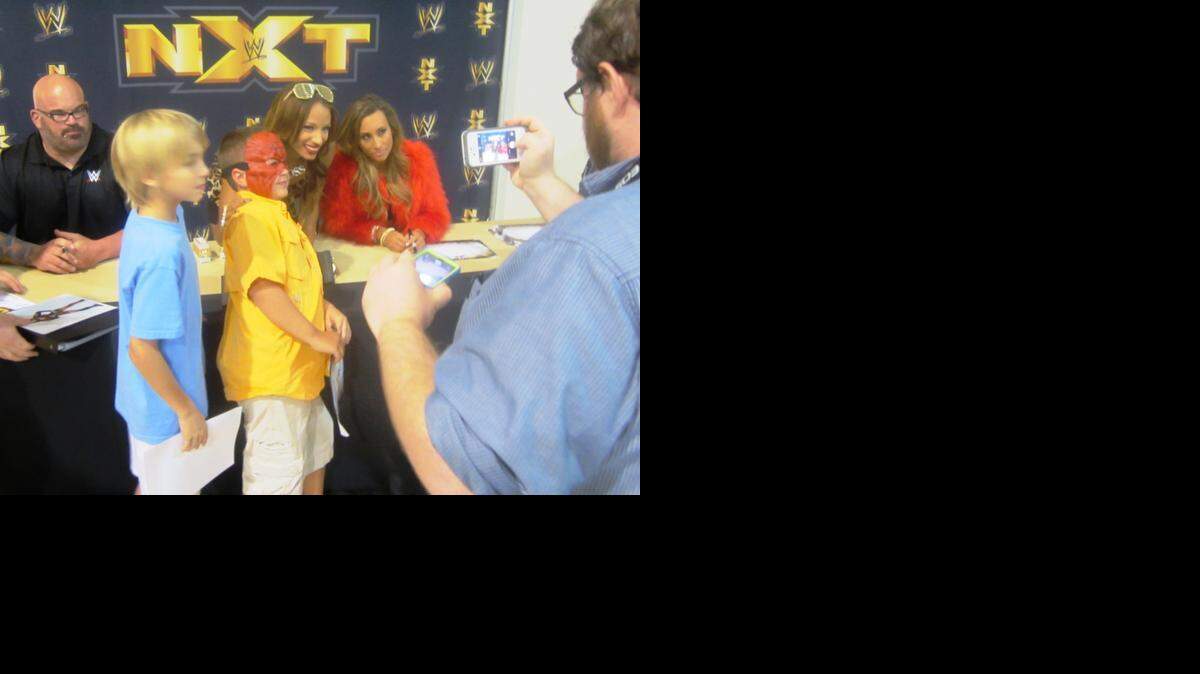 
NXT divas Sasha Banks and Carmella, along with former WWE superstar Tensai, who is current WWE NXT trainer Matt Bloom, sign autographs and pose for photos with fans before a WWE NXT show in August at the Havert L. Fenn Center in Fort Pierce. A pre-show meet-n-greet is part of the NXT house show experience. NXT returns to the Havert L. Fenn Center on Saturday, Oct. 4.
