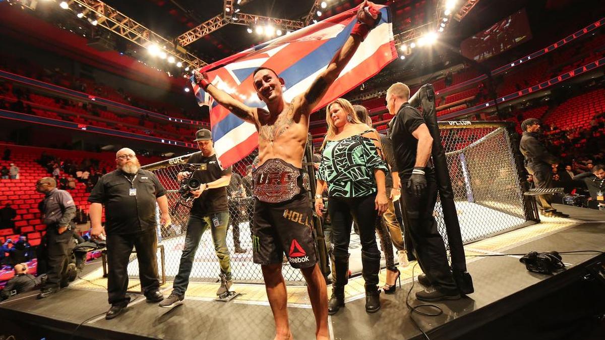 UFC Featherweight Champ Max Holloway celebrates after defeating Jose Aldo at UFC 218 on Saturday, Dec. 2 at Little Caesars Arena in Detroit.