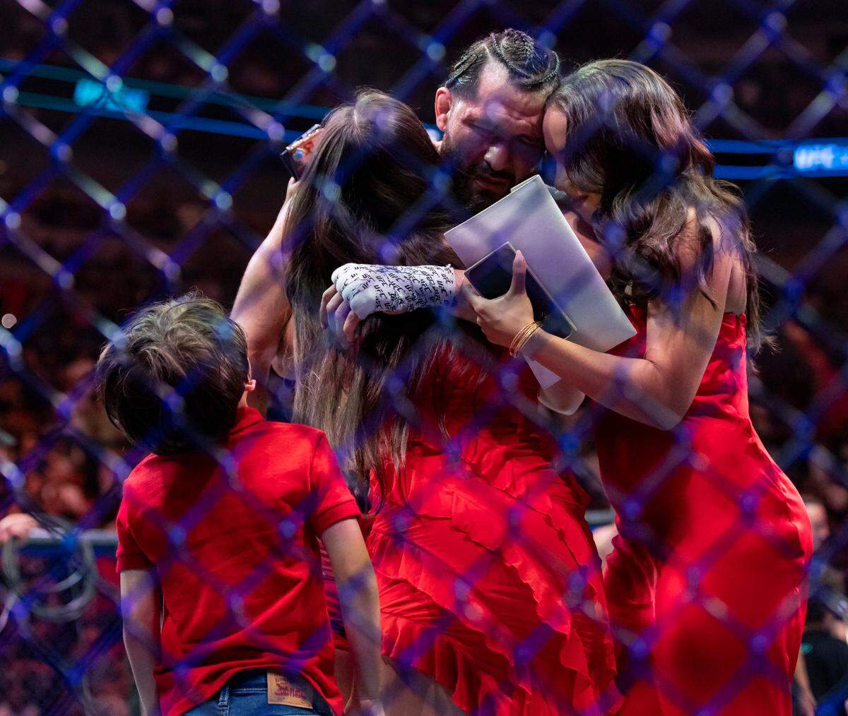 Jorge Masvidal hugs his family after losing his welterweight title match against Gilbert Burns during the UFC 287 event at the Kaseya Center on Saturday, April 8, 2023, in downtown Miami, Fla.
