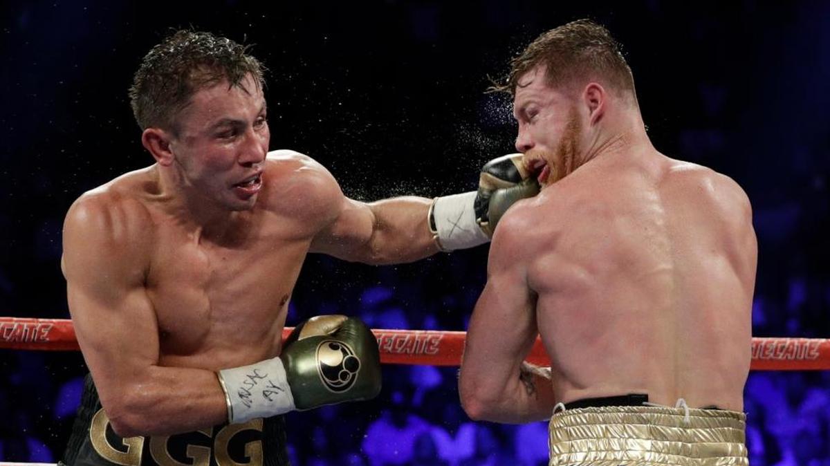 Gennady Golovkin, left, hits Canelo Alvarez during a middleweight title fight Sun., Sept. 17, 2017, in Las Vegas.