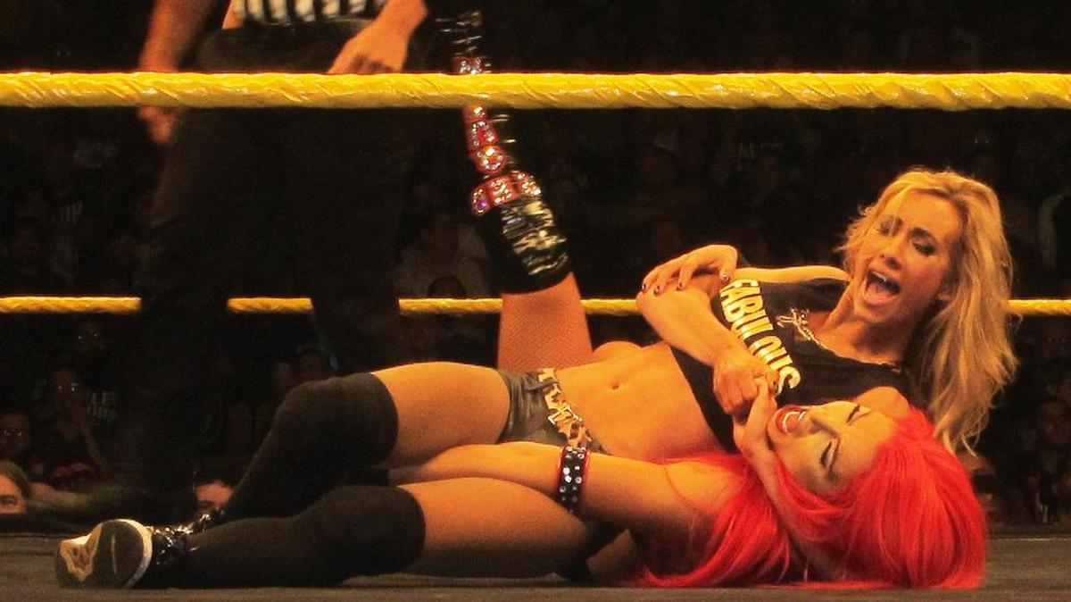 WWE Superstar Carmella headlocks Eva Marie during their NXT days at an NXT event in January at the UCF Arena in Orlando.