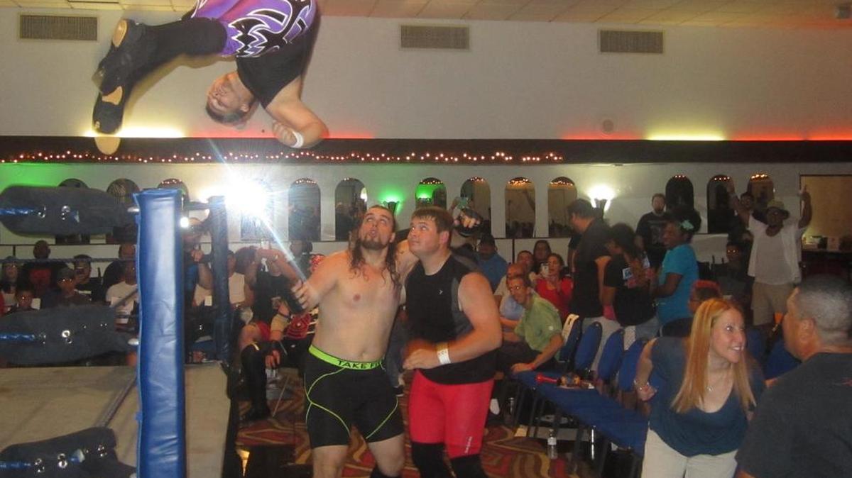Chris Braddock goes airborne against Matias Cage and Zach Cooper at X-Wrestling 7 at the Polish American Club, 1250 NW 22nd Ave. in Miami.