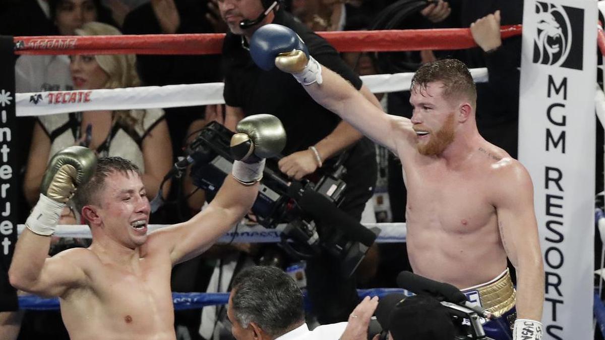 Canelo Alvarez, right, and Gennady Golovkin celebrate after their middleweight title fight Sept. 17, 2017, in Las Vegas. The fight was called a draw.