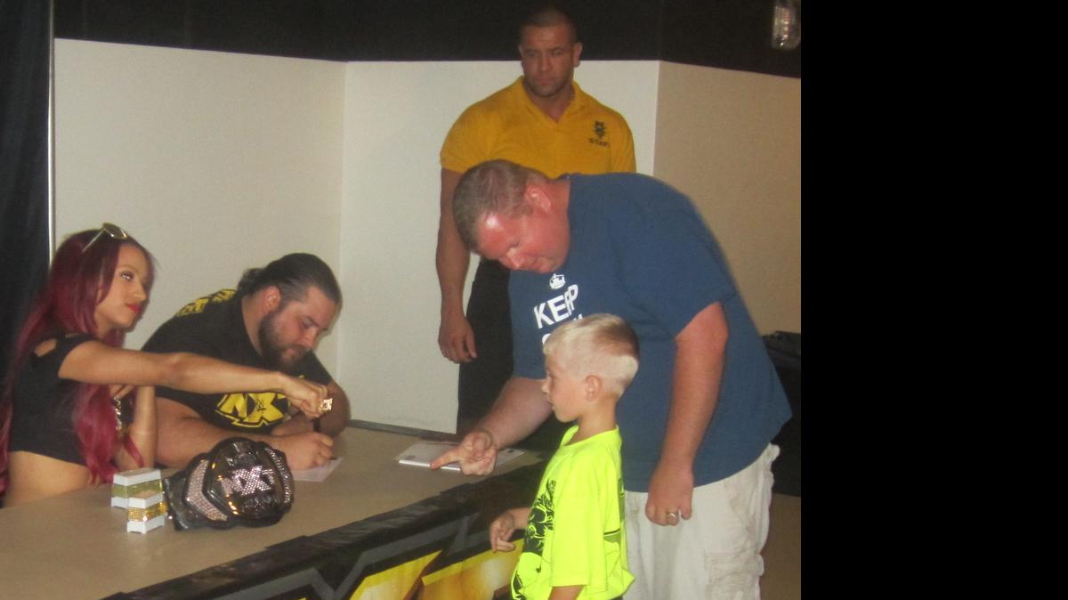 
The Boss Sasha Banks shows off her bling which includes rings, necklaces, autograph stampers and especially her NXT women’s championship belt during a meet-n-greet with fans before a WWE NXT show at the Havert L. Fenn Center in Fort Pierce. NXT returns to the Havert L. Fenn Center on June 5. Also pictured is Bull Dempsey.
