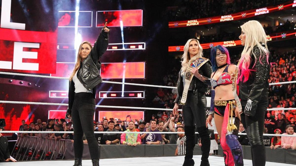 Former UFC star Ronda Rousey made a surprise appearance to close the WWE Royal Rumble on Sunday, Jan. 28 from the Wells Fargo Center in Philadelphia. WWE’s newest superstar, Rousey confronted SmackDown Women’s Champ Charlotte Flair, Women’s Royal Rumble winner Asuka and Raw Women’s Champ Alexa Bliss. Rousey pointed at the WrestleMania 34 banner.
