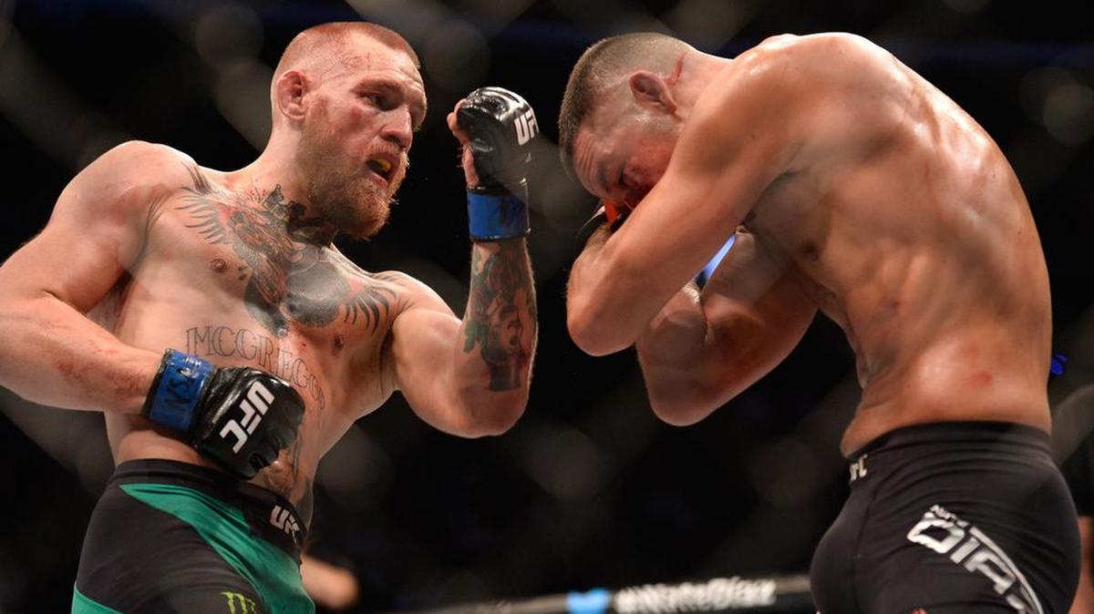 Conor McGregor punches Nate Diaz in their welterweight bout during UFC 202 at T-Mobile Arena on Aug. 20, 2016 in Las Vegas. McGregor will fight on the main card of UFC 205 at the highly anticipated debut at historic Madison Square Garden on Saturday, Nov. 12 in New York City.