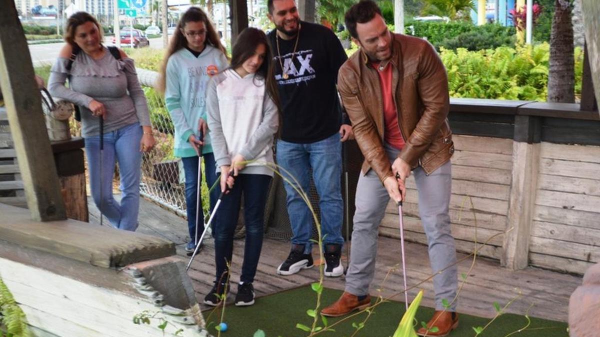Former Impact Wrestling Champ Eli Drake (putting) won the wrestlers’ division of the Impact Wrestling Mini-Golf Championship on Saturday, Jan. 13 at Congo River Golf in Orlando. Drake was paired with the Felipe family from Miami.