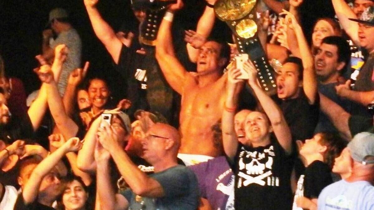 Alberto El Patron (formerly WWE’s Alberto Del Rio) celebrates with fans in the crowd after beating Bobby Lashley to unify the Global Force Wrestling and Impact Wrestling titles in the main event of the Slammiversary XV pay-per-view from Universal Studios Florida in Orlando.