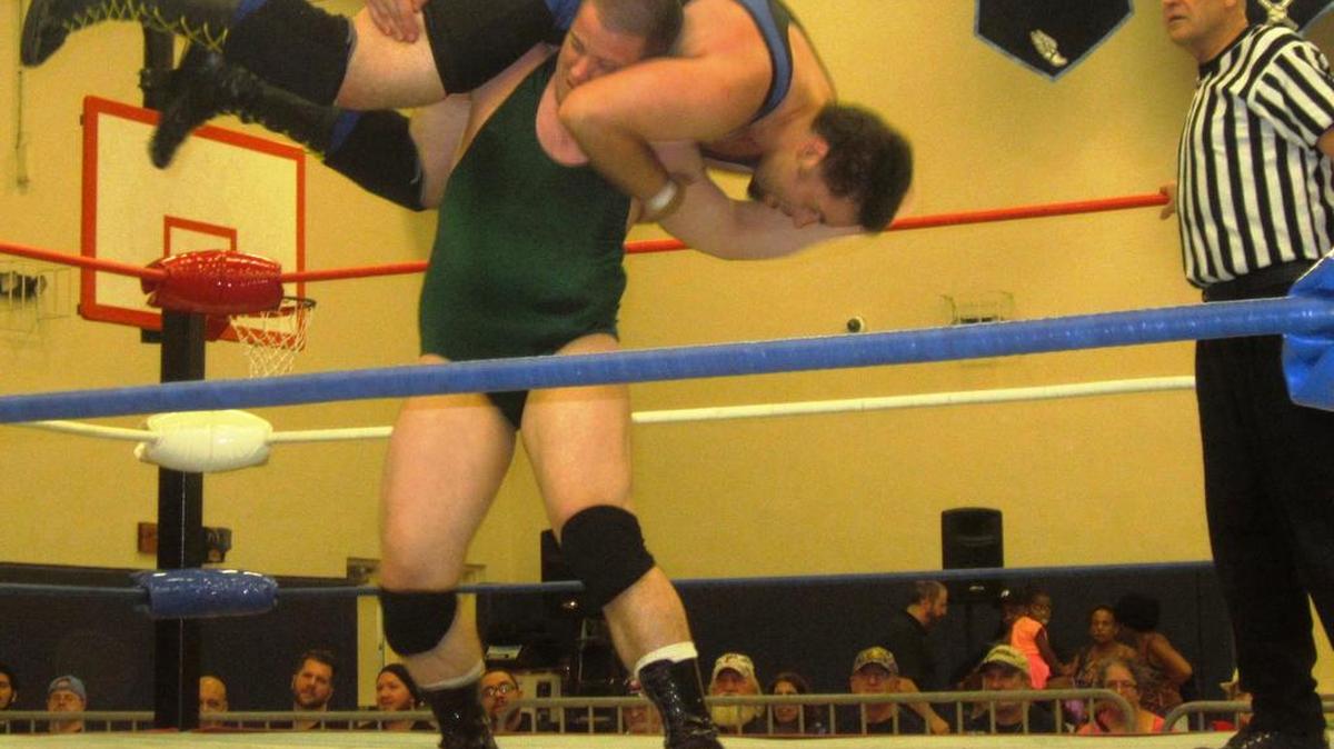 
Wrestlers Craig Classic (delivering standing fireman’s carry on Dan Embry) and Jonny Vandal are joining forces to start Brain Buster Pro Wrestling, based in South Florida. Your referee is Bruce Owens.
