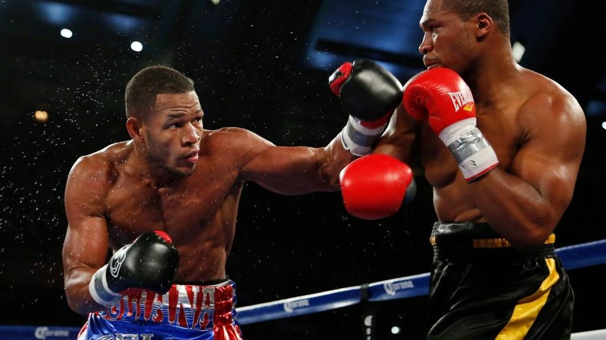 Sullivan Barrera, left, throws a left at Rowland Bryant during the third round of a light heavyweight boxing bout in Atlantic City, N.J., on Saturday, Nov. 8, 2014. Barrera won when the first was stopped after the fourth round.