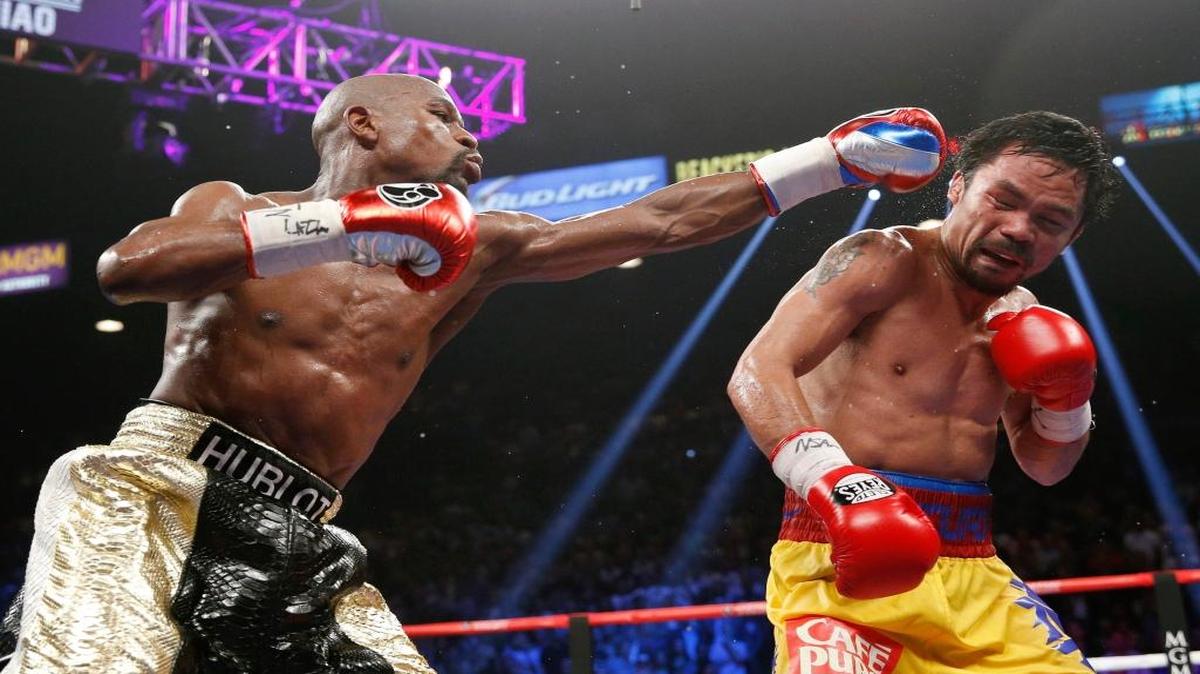 File photo: Floyd Mayweather Jr., left, hits Manny Pacquiao, from the Philippines, during their welterweight title fight in Las Vegas. The broadcast of fight was marred by technical snafus and got sucker punched by Internet streamers, exposing the industryÂ's vulnerabilities.